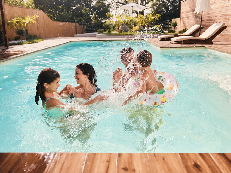 a group of people swimming in a pool of water